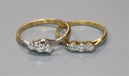 Two 18ct gold and diamond set dress rings.